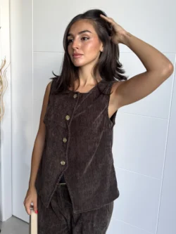 Modelo con chaleco marrón sin mangas abotonado